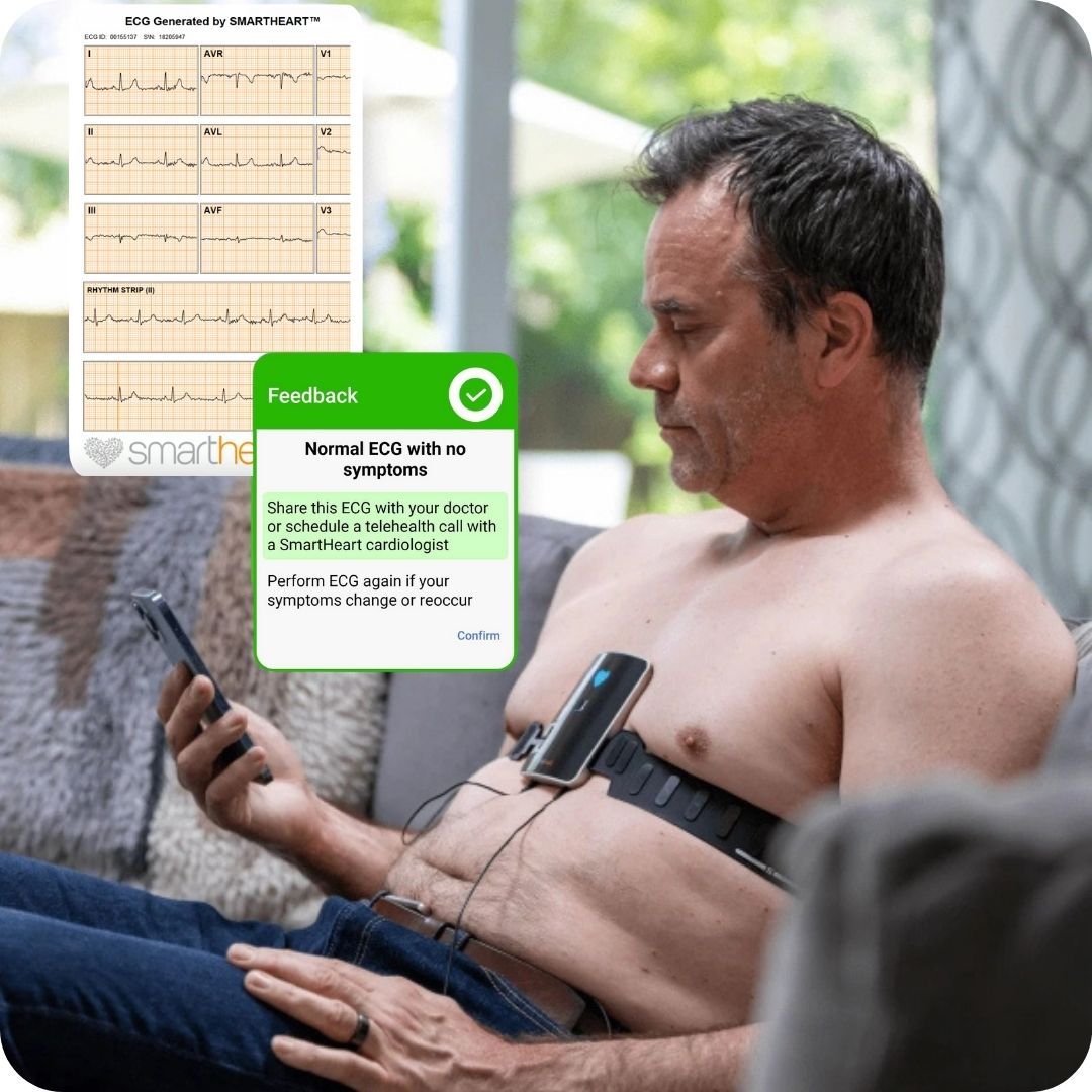 Middle-aged man seated on his home sofa wearing the SmartHeart portable 12-lead EKG device, with a hospital-grade ECG waveform visible and a feedback overlay highlighting normal results, from SmartHeart 24/7 cardiologist review.