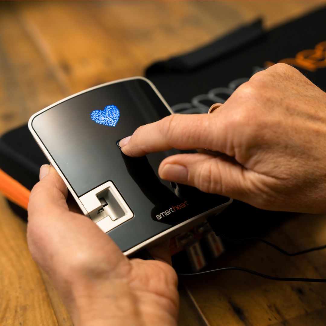 Front view of SmartHeart EKG device highlighting the power button