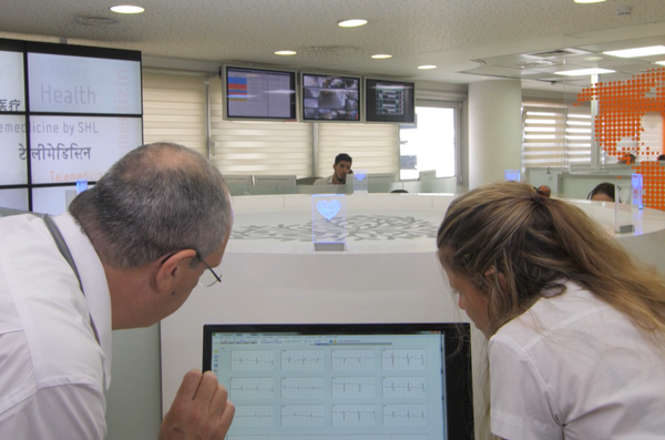 Clinician reviewing EKGs on a laptop