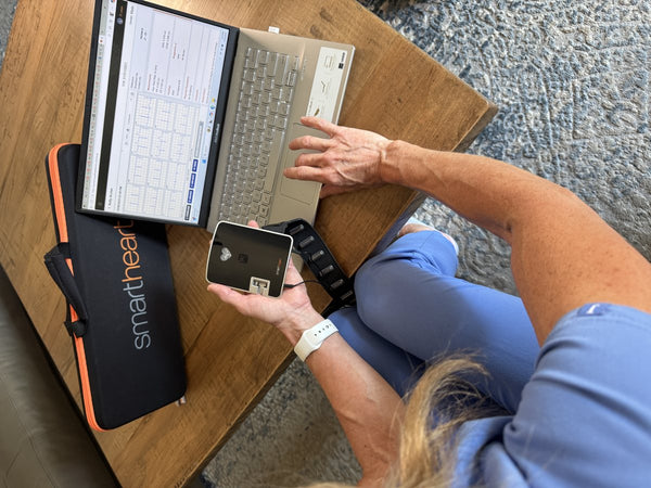 Clinician reviewing EKGs on a laptop